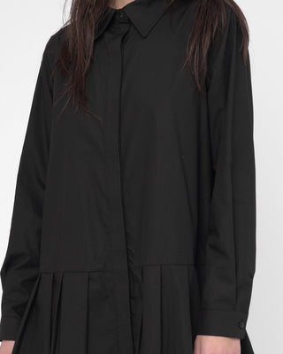 Black shirt worn by a person on a white background