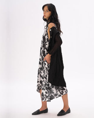 Woman wearing a black and white floral dress on a white background