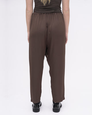 Brown pants worn by a person on a white background
