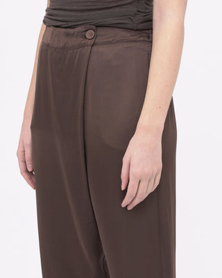Brown pants worn by a person on a white background