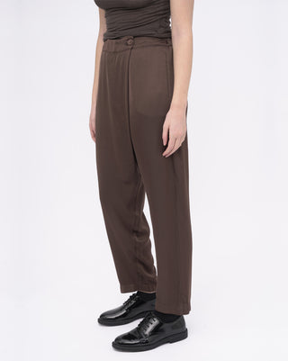Brown pants worn by a person on a white background