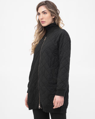 Woman wearing a black quilted jacket on a white background