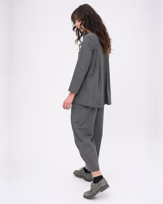 Woman wearing a gray outfit on a white background