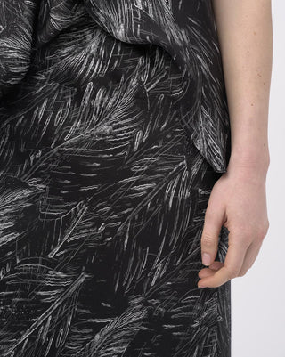 Close-up of a black dress with white abstract pattern on a white background