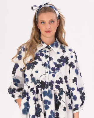 model wearing a floral print maxi dress by baci fashion against a white background 