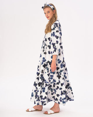 model wearing a floral print maxi dress by baci fashion against a white background 