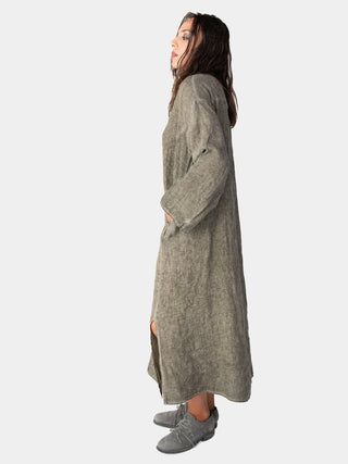 a model wearing a sage green dress against a white background