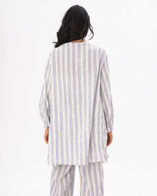 the back of a model wearing a light blue and white striped outfit against a white background
