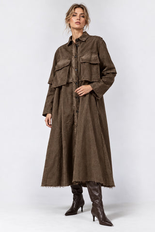 a blonde model wearing an all brown outfit against a white grey background by baci fashion