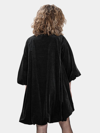 Person wearing a black oversized shirt on a white background