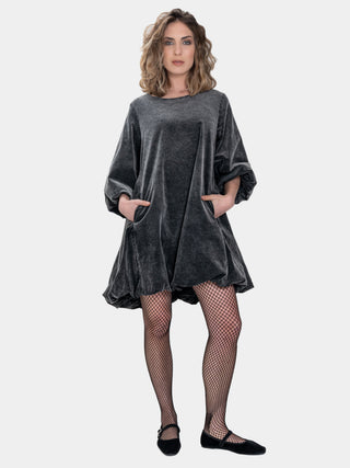 Woman wearing a gray velvet dress on a white background