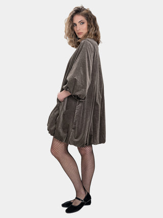 Woman wearing a gray velvet dress on a white background