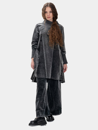 Woman wearing a gray velvet outfit on a white background