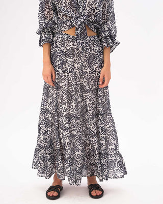 Person wearing a black and white patterned dress on a white background