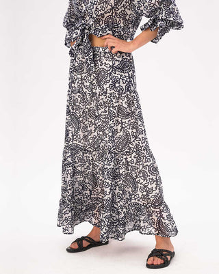 Person wearing a black and white patterned dress on a white background