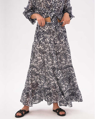 A person wearing a black and white patterned outfit by Baci Fashion on a white background
