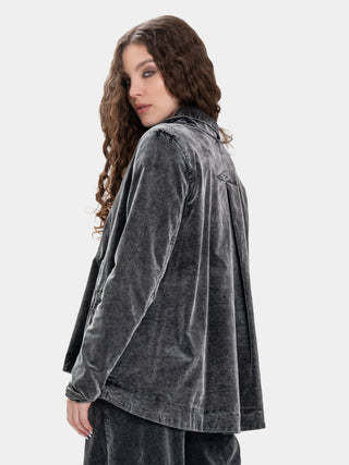 Woman wearing a gray velvet jacket on a white background