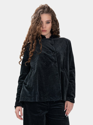 Woman wearing a black velvet jacket on a white background