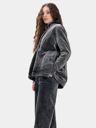 Woman wearing a gray velvet outfit on a white background