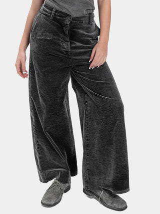 Person wearing wide-leg black jeans on a white background