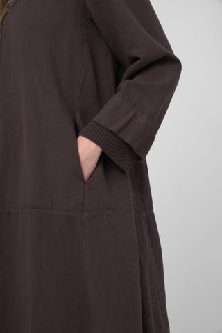 Brown dress with a pocket on a light gray background