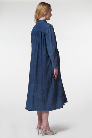 Woman wearing a long blue dress on a white background