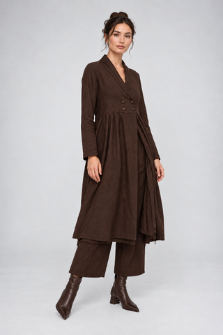 a brunette model wearing an all brown outfit against a white grey background