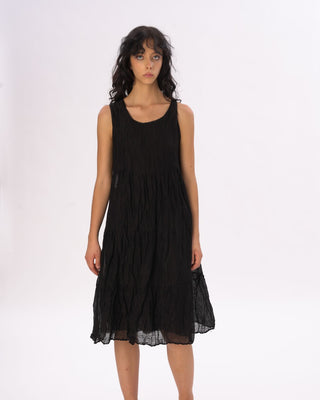 Woman wearing a black dress against a white background