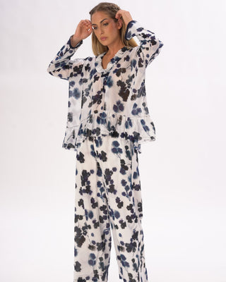 model wearing a floral print outfit in front of a white background