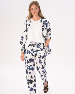 model wearing a floral print outfit with a white tshirt against a white background