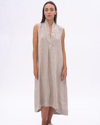 women wearing a beige dress against a white background.
